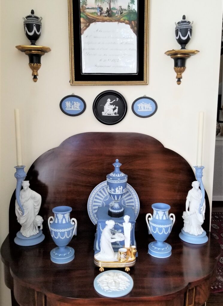 Blue jasperware collection arrayed on sideboard.