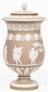 Wheat-colored jasper urn with classical figures and patterns.